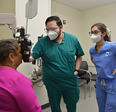 Patient having an eye exam with a doctor and assistant