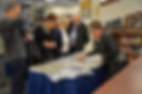 People reviewing documents on a table in a library