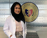 Woman in lab coat and hijab at Illinois College of Optometry
