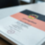 A professional and realistic image showing a diploma document placed on a table, with the