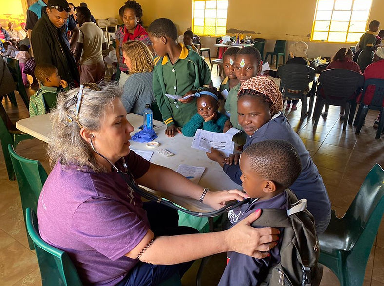 Child receiving health care from a Kudvumisa clinic volunteer