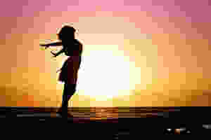 Woman on beach at sunset