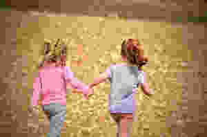 Two girls running, hand in hand