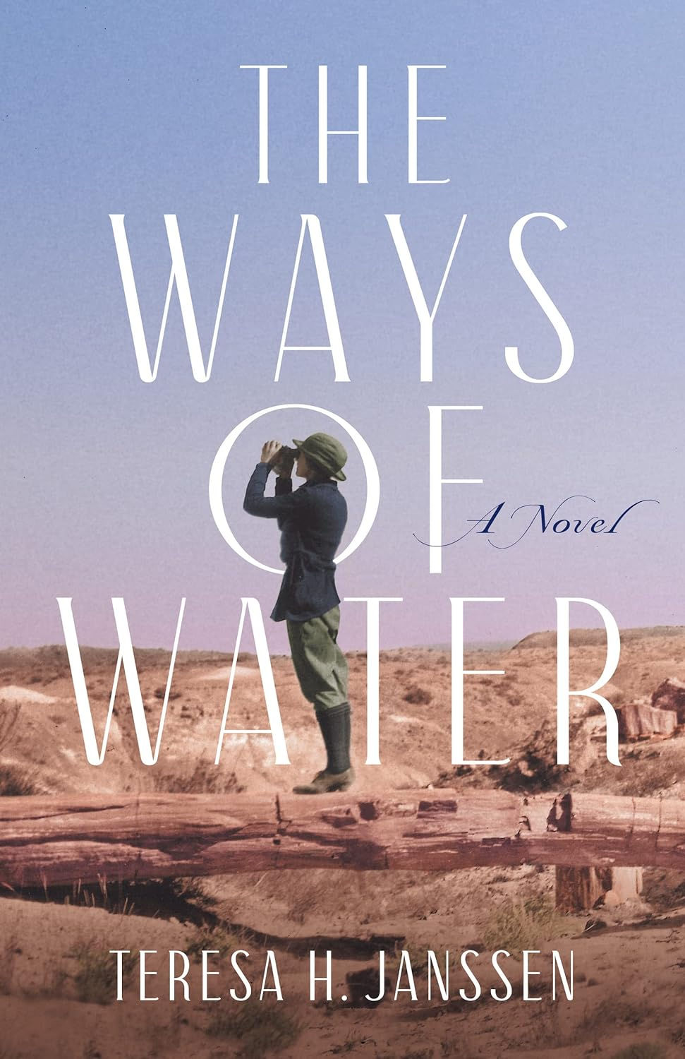A young woman in early 20th-century trousers, jacket, and hat aims binoculars at a clear blue desert sky. She is standing in a rocky desert. Cover of The Ways of Water.