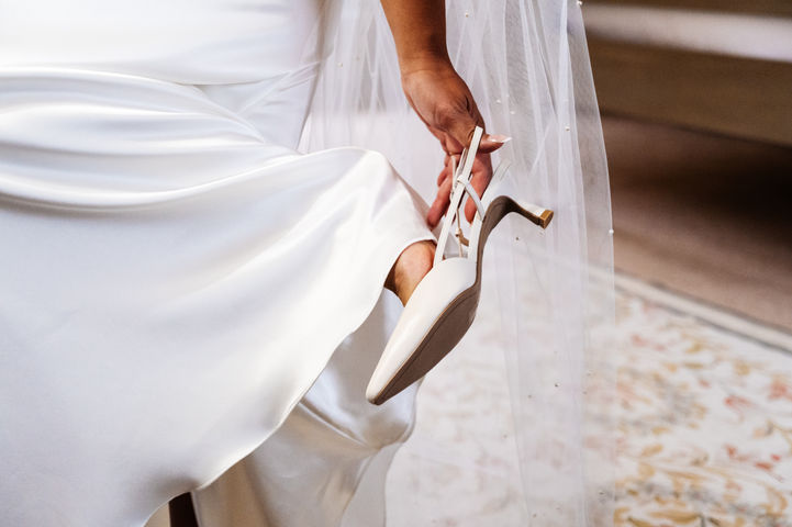 Bride putting wedding shoes on
