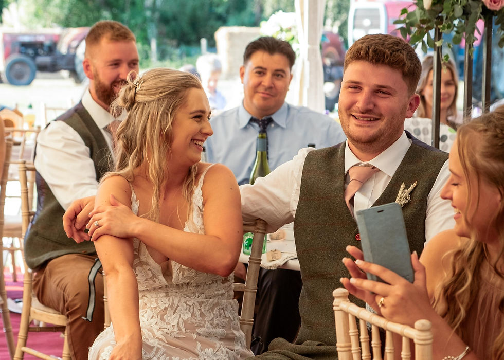 Bride and groom looking at each other during speeches