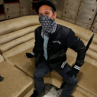 Our beloved bartender Kenny wearing a Mac's Club Deuce black satin bomber jacket and neck gator. You can see the Cash Only logo on the front left corner of the jacket. The neck gator is imprinted with small Mac's Club Deuce logos.