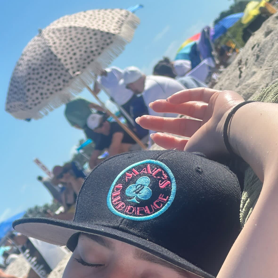 One of our favorite people wearing the Mac's Club Deuce logo in Miami Vice pink and blue on a snapback baseball cap at the beach.