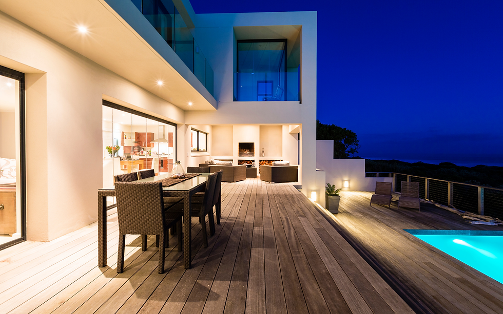 Modern house at night, deck with pool