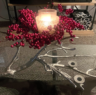 A silver branch candelabra adorned with holly berries offers a festive yet elegant way to elevate any setting. The delicate s