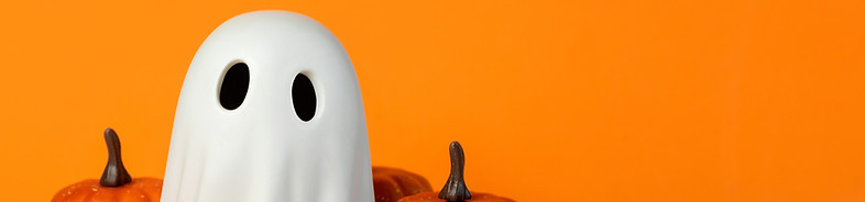 Funny Halloween ghost and Halloween pumpkins with space for text over orange background. H