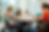 four people at a table; a woman in a wheelchair, two women across from each other, and a Black man