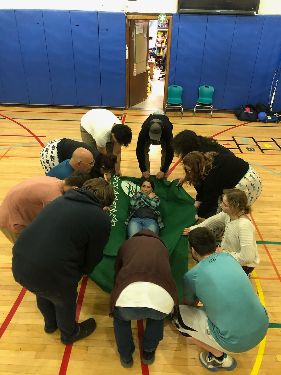 Woman holding coffee cup looking mildly worried while looking at a computer screen