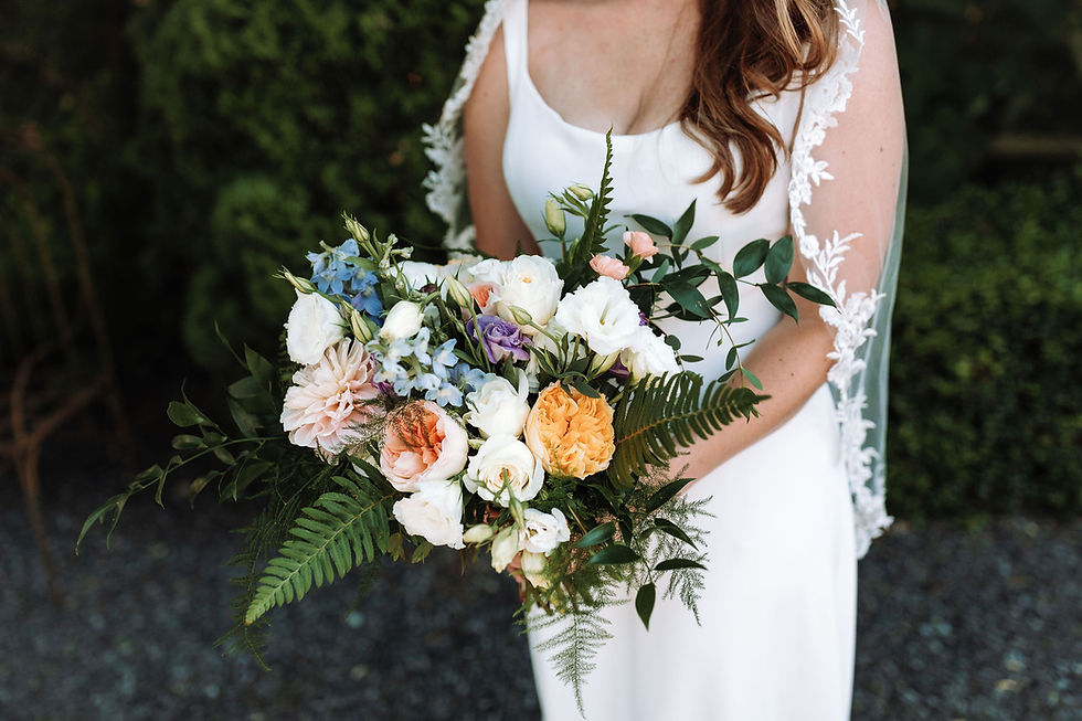 pink, blue and lavender wedding bouquet with ferns.
