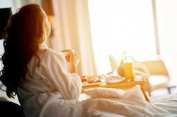 breakfast-bed-cozy-hotel-room-260nw-1037078773_edited