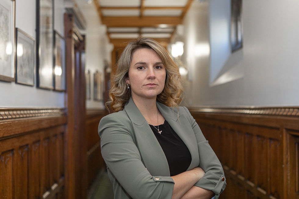 Jess Brown-Fuller standing in a corridor, facing the camera head-on.