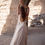 Thumbnail: Woman in The Willow Gown - Vintage Lace Wedding Dress with High Slit raising arms