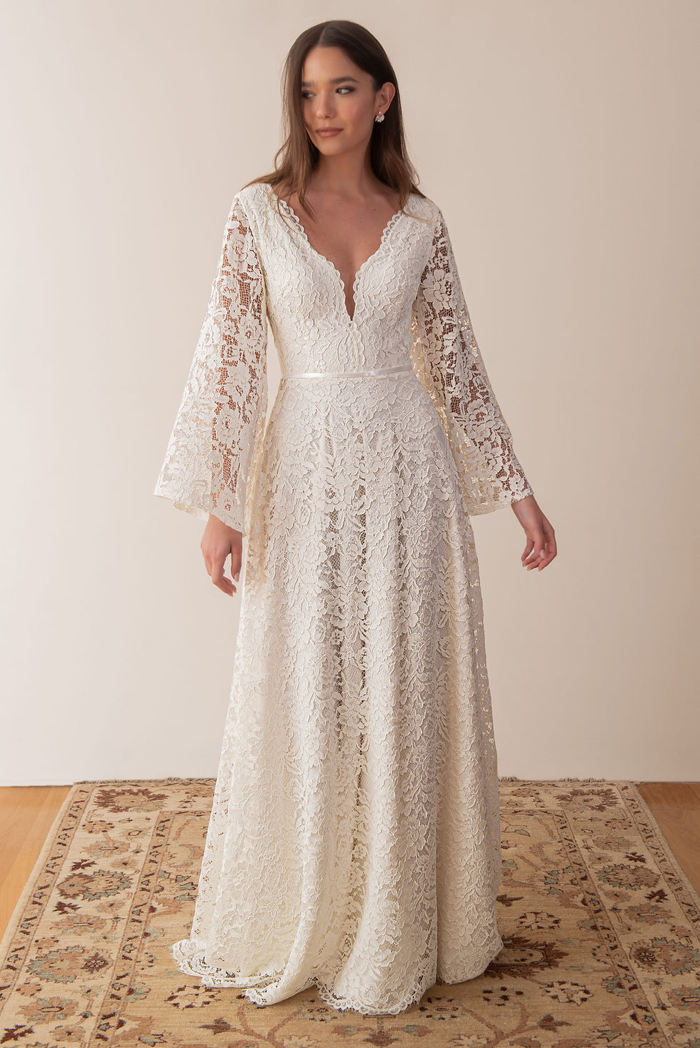 Thumbnail: Bride wearing a lace wedding dress with floor length romantic wedding veil