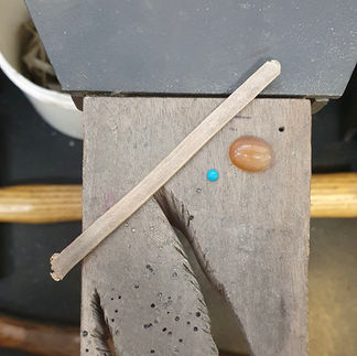 A gold wire and some gemstones
