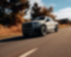White Ford F-150 Raptor driving on road