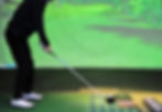 Golfer in a golf simulator bay