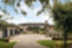 Modern stone home exterior at Sienna Bend with paved driveway