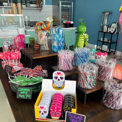 Candy display with lollipops, skull candies, and text at Sugar Shack shop.