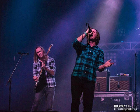 Two musicians performing live on stage