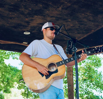 Man playing acoustic guitar and singing live