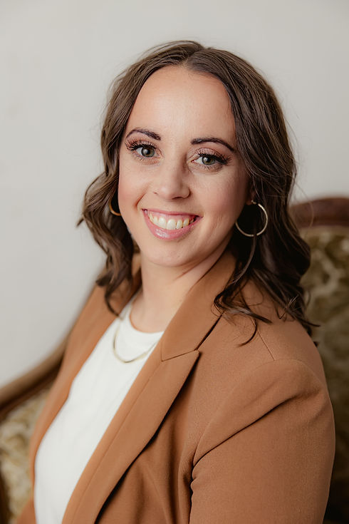 A cheerful woman smiling warmly, radiating happiness and confidence.