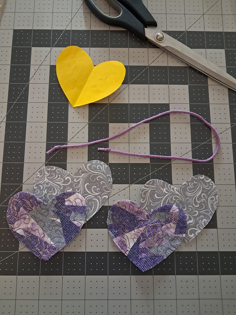 Two scrap hearts for the front, two hearts for the back, one length of yarn with knots on both ends.