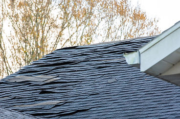 damaged composition shingle roof 