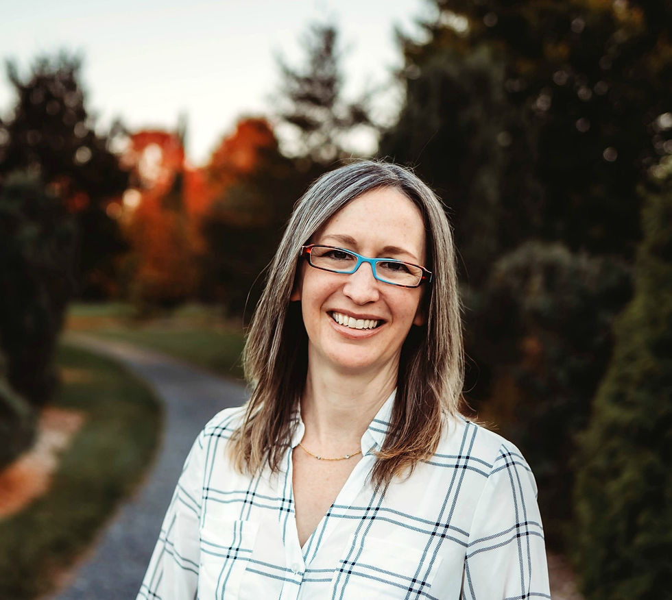 Smiling white woman with brown hair and eyegalsses