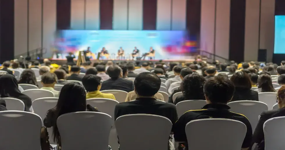 cropped-rear-view-audience-listening-speakers-stage-conference-hall-seminar-meeting_41418-