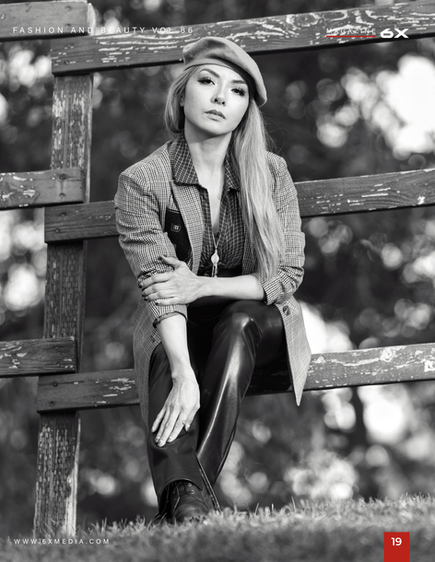 Black and white portrait of woman sitting on fence in outdoor setting by Abram Katz.