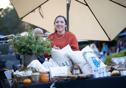 Festival vendor serving attendees at a Southern Oregon event by Abram Katz