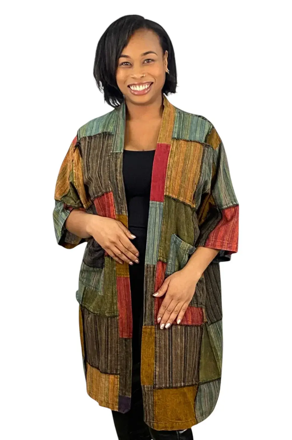 Front view of model in primarily green colored patch open jacket with 3/4 sleeves