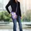 Thumbnail: Model in denim clothing with Gifts From Creator phone bag hanging on shoulder