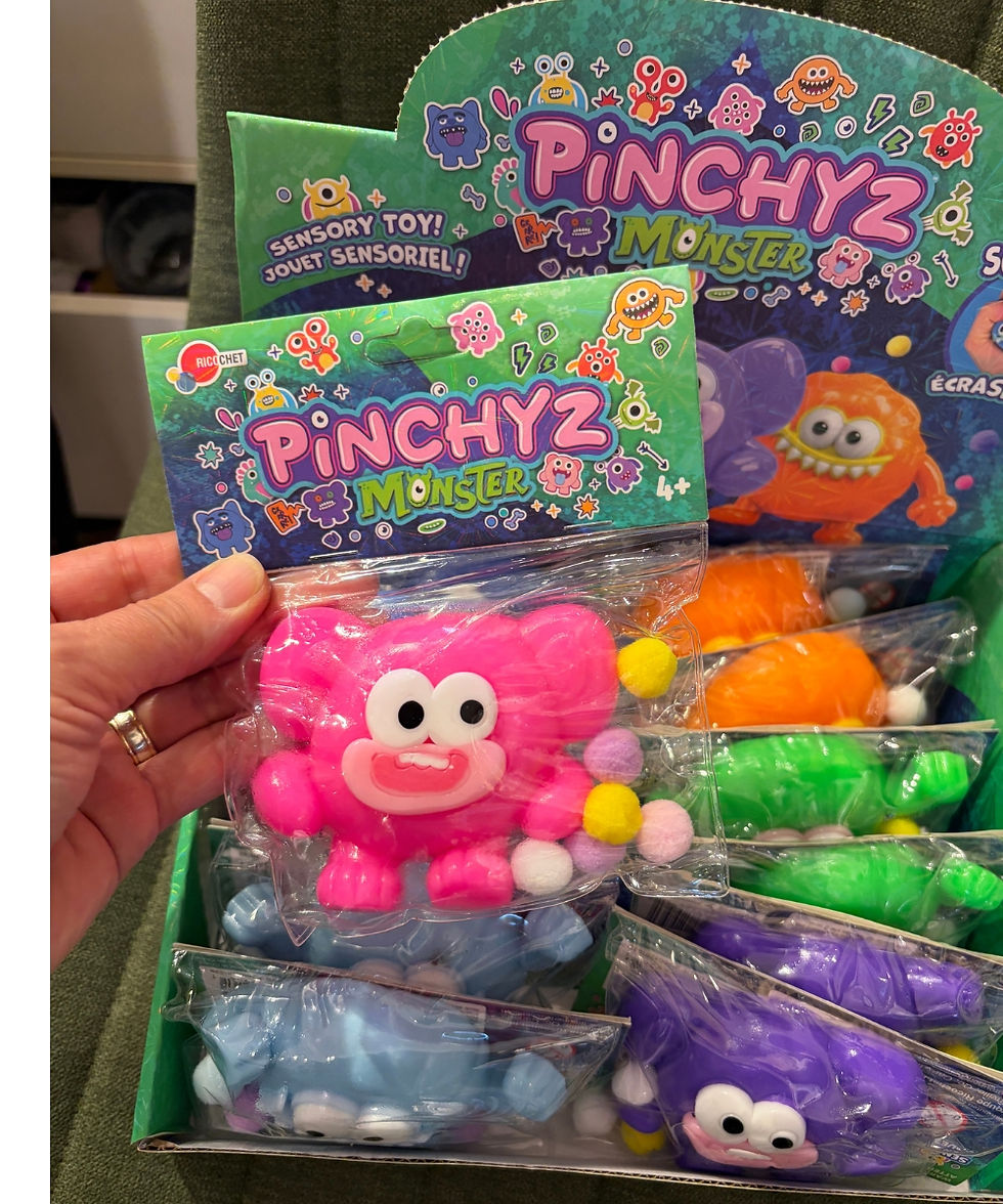 A Pinchyz Monster squishy sensory fidget toy with pompom accents at Tickled Pink.