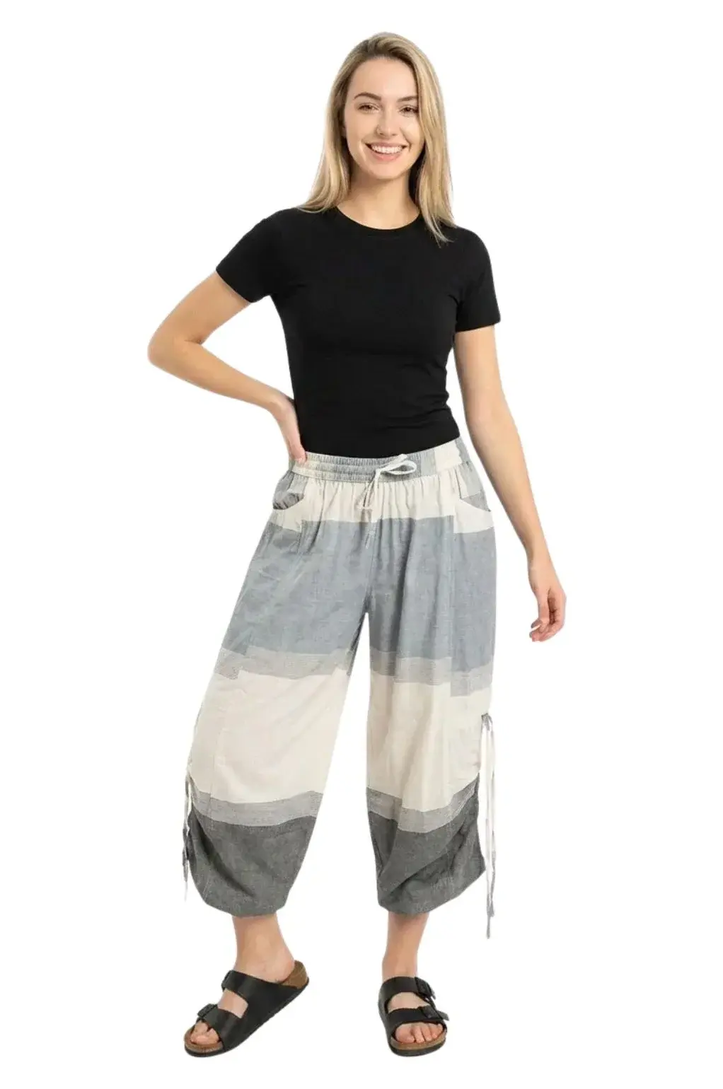 Model in loose fit large block natural gray & charcoal pant with elastic drawstring waist, cinch ties at knee, outer pockets