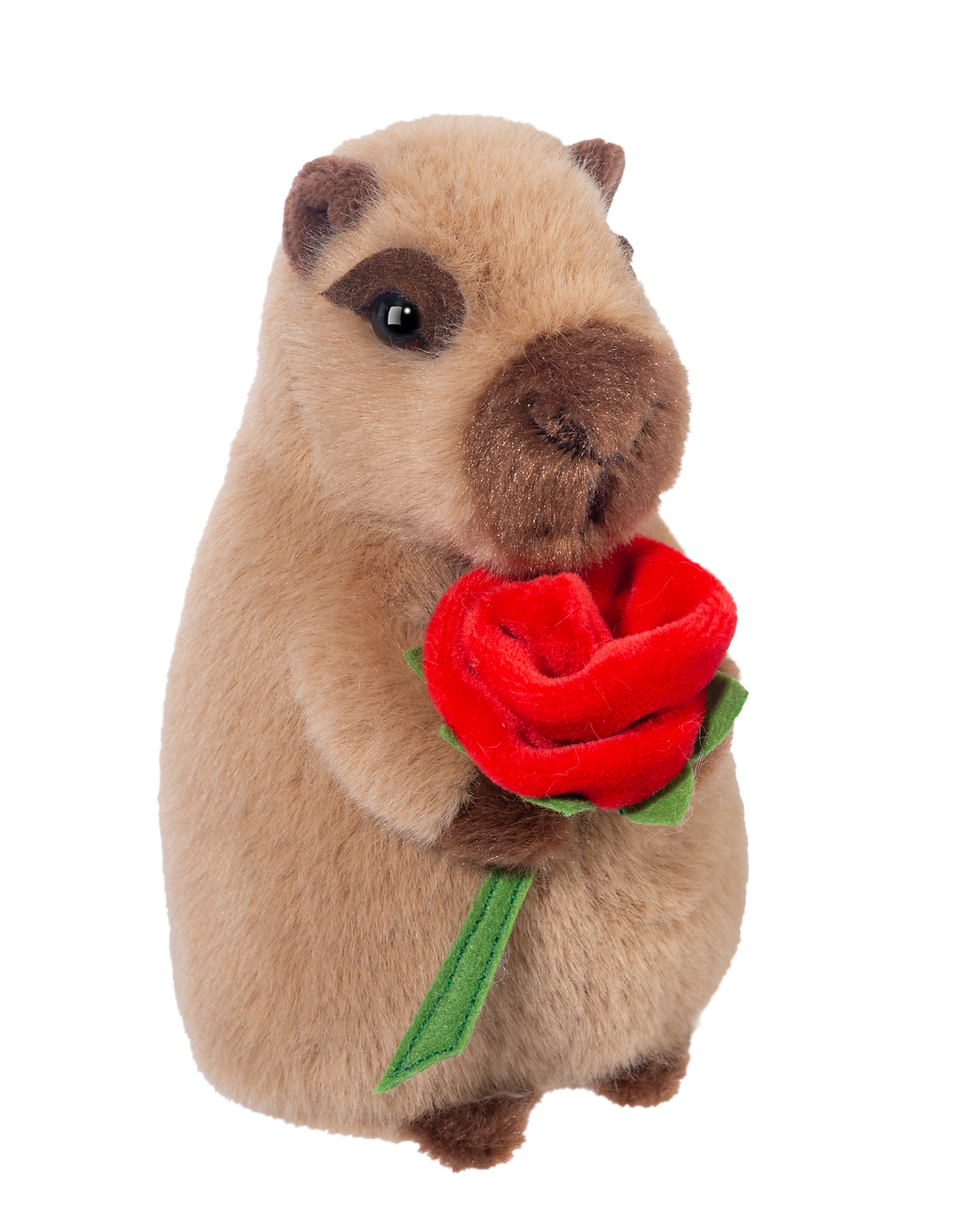 Brown stuffed toy capybara on hind legs holding red rose