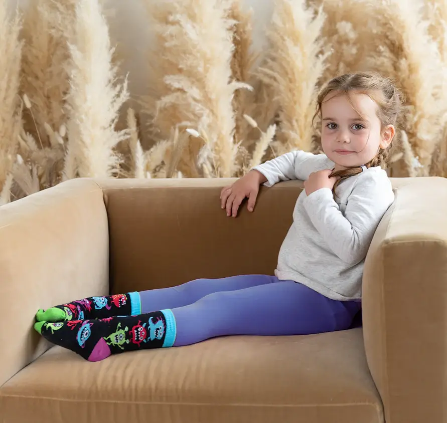 Front view of Monster Mash kids socks featuring friendly monster illustrations by Uptown Sox at Tickled Pink Ottawa.