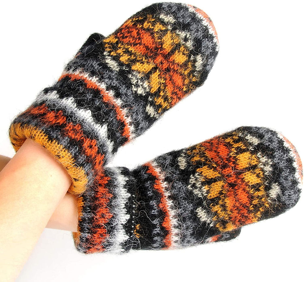 Rust, orange black white & gray snowflake patterned knit wool mitts on hands