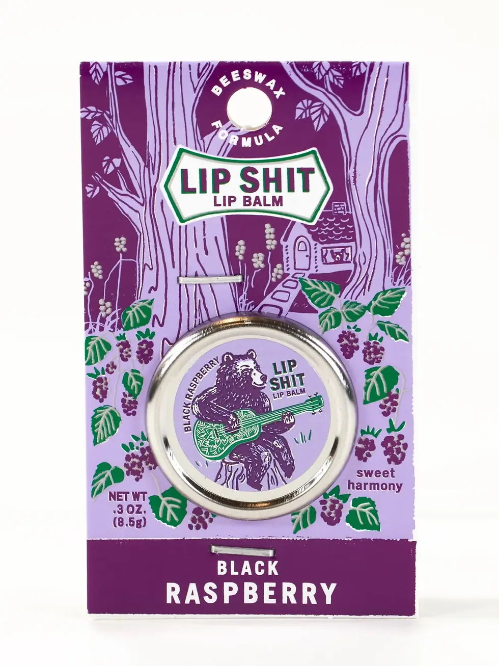 Purple & white cardboard package with round tin of Black Raspberry lip balm, bear playing guitar on lid, text, 'Lip Shit'