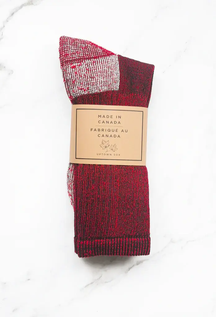 Red & black socks with white heel & toe folded with brown paper banded around them
