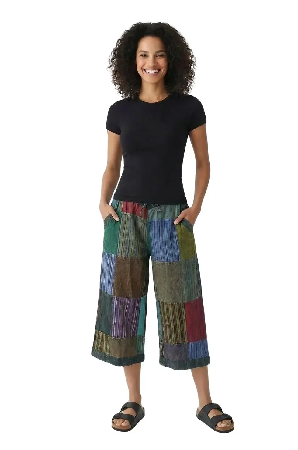 Model showing predominantly teal patchwork mid-calf-length pants with criss-crossed drawstring at front waist