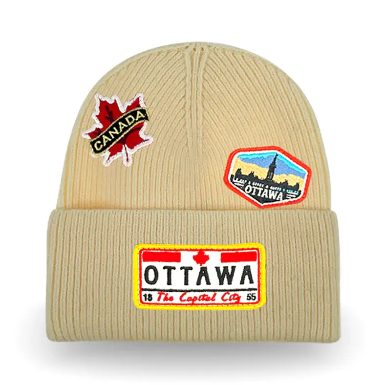 Thumbnail: Ivory knitted cuffed toque with Ottawa patches stitched on