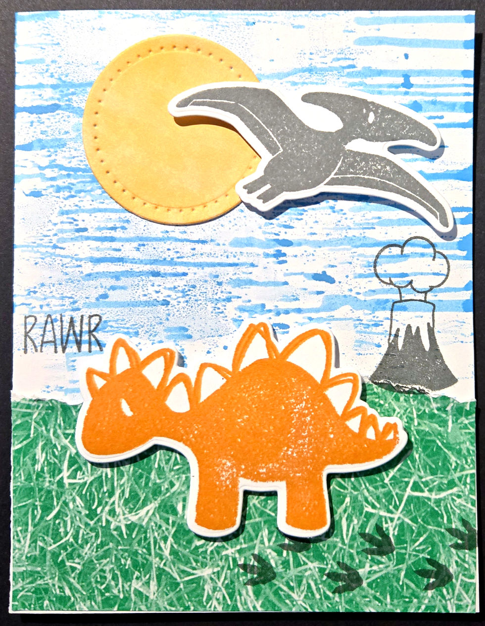 Thumbnail: Blue & green inked background on handmade card with orange dinosaur & gray pterodactyl against yellow sun