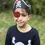 Thumbnail: Black headband in shape of pirate hat with skull & crossbones & red eye patch on model