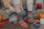 Brown, blue & orange mismatched striped patterned socks on model